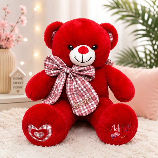 Red teddy bear with plaid bow and heart patch